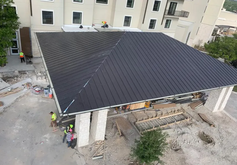Metal roofing installation team working on a commercial building in Capitol View
